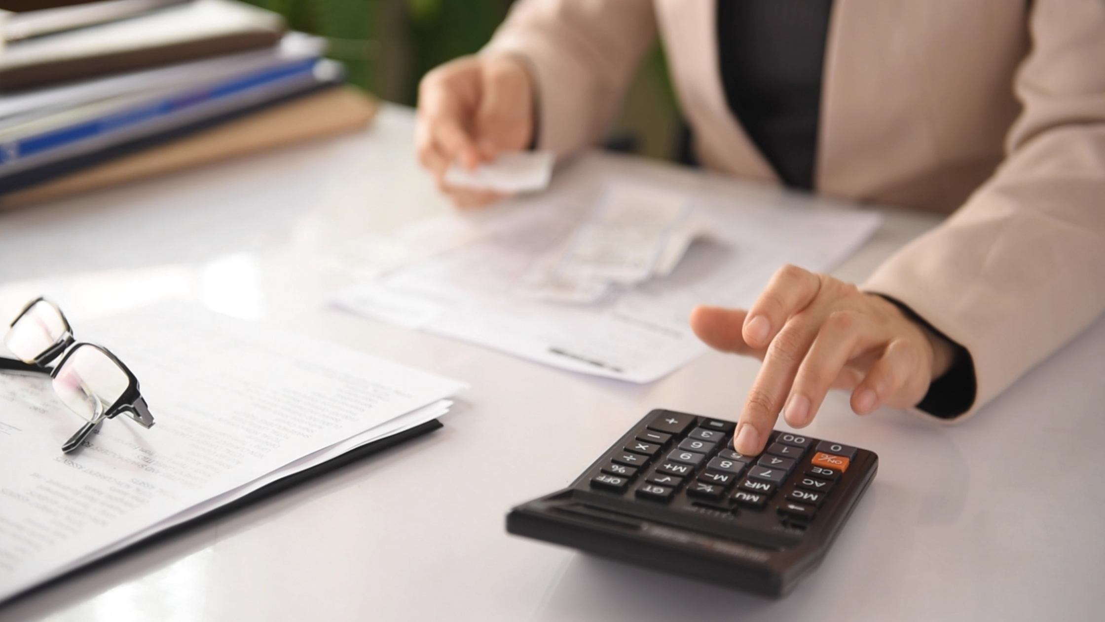 entrepreneur at desk with receipts and calculator
